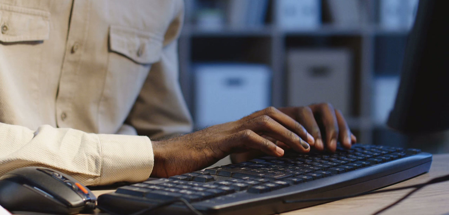 Hands typing on a keyboard
